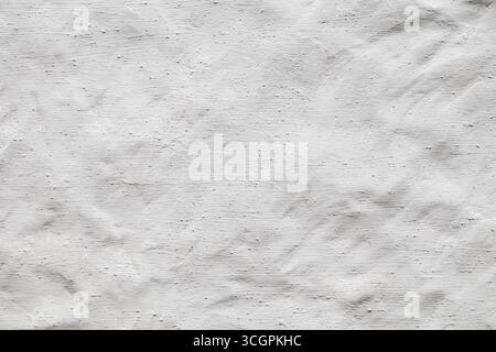background wall white, roughly painted with matte paint with streaks and streaks Stock Photo