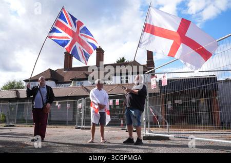 Protesters outside the Bell Hotel after a temporary injunction that would have blocked asylum seekers from being housed at the hotel in Epping, Essex, was overturned at the Court of Appeal. Picture date: Friday August 29, 2025. Stock Photo
