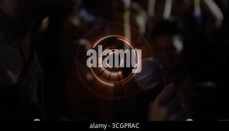Floating circular interface hovering in nightclub, with woman in sleeveless top holding smartphone Stock Photo