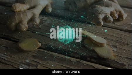 Hovering wireframe sphere over wooden kitchen table with ginger root round slices and digital nodes Stock Photo