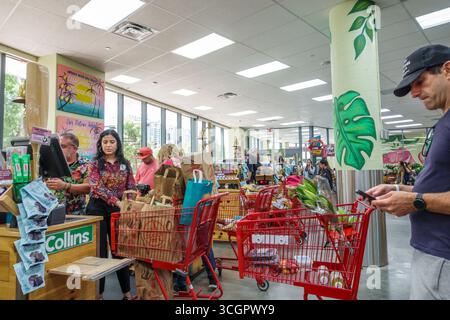 Miami Florida,Trader Joe's,grocery food store supermarket,inside interior,checkout counters line queue customers,employees staff cashiers register cou Stock Photo