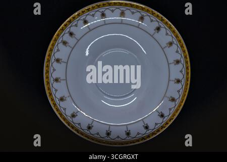 Elegant white porcelain saucer with golden rim Stock Photo