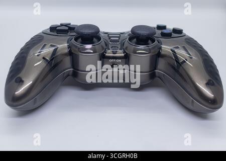 Ergonomic Black Gamepad with Textured Grip and Dual Analog Sticks on White Tabletop Background Stock Photo