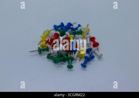 Mixed Color Thumbtacks for Office and School Use on Clean Surface Stock Photo