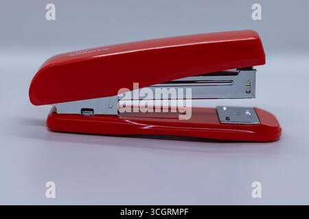 Plastic stapler with steel handle white backdrop Stock Photo