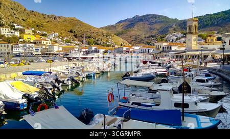 Panoramic view of Hydra harbor with boats and traditional stone houses, Hydra island, Greece. Stock Photo