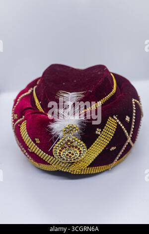 Royal Red and Golden Turban with Embellished Jewel and Elegant Design Stock Photo