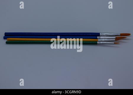 Set of Colorful Artist Brushes for Painting and Craft Work on Minimal Background Stock Photo