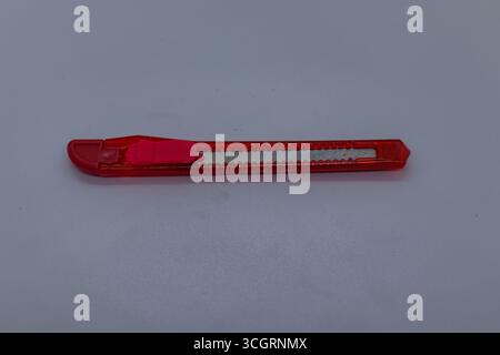 Small Red Cutter Knife for Craft and Packaging Work on Clean White Background Stock Photo