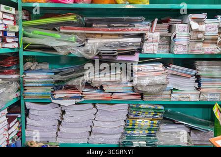 Stacked colorful notebooks and files on stationery shop shelf Stock Photo