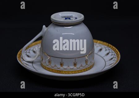 The cup is designed with a delicate handle, perfect for holding hot beverages such as tea or coffee Stock Photo