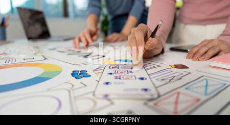 Hands on UX and UI Design. Team members sketching ideas and wireframes on a collaborative project. Stock Photo