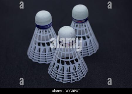 White Feather Shuttlecock on Plain Surface Stock Photo
