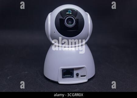Wired CCTV camera system on black backdrop Stock Photo