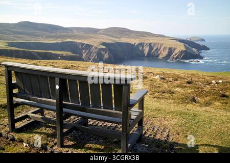 empty park bench overlooking the arranmore cliffs and views out to the atlantic ocean arranmore island county donegal republic of ireland Stock Photo