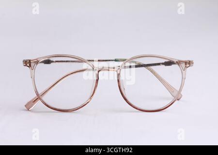 Oval round glasses isolated on white background. Minimalist glasses display with close up view. Stock Photo