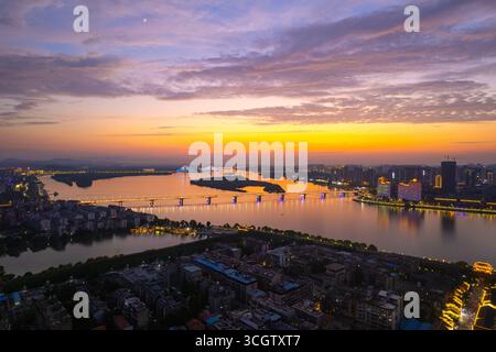 Xiangyang City China river bridge skyline at sunset shows colorful sky. Stock Photo