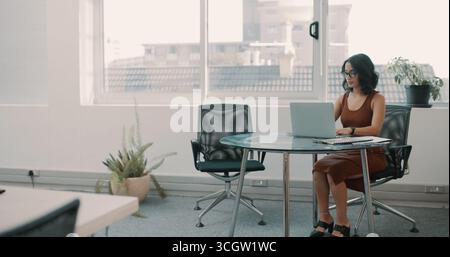 Office, admin and business woman on laptop for hr management, compliance and company policy. Professional, corporate space and person on computer for Stock Photo