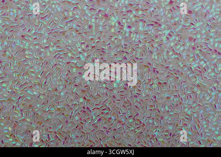Full frame macro abstract texture background of sparkling pink and white color glitter surface with unique cylinder shaped glitter specks Stock Photo