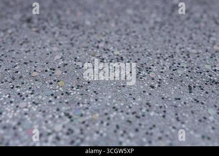 Full frame macro abstract texture background of defocused silvery black glitter surface with copy space Stock Photo