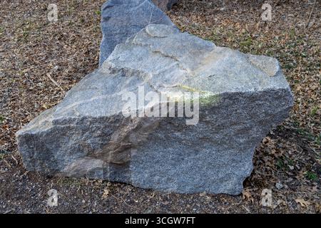 Macro abstract texture background of a multicolor natural granite stone boulder surface Stock Photo