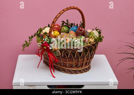 decorated basket with Easter eggs and Easter cake, also horseradish with sausage and ham and butter with cheese Stock Photo