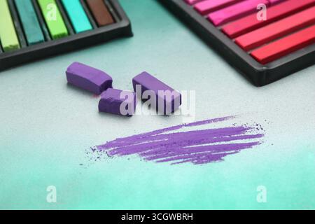 Colorful chalk pastels in trays on color background, closeup Stock Photo
