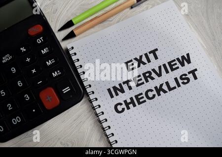 Concept of exit interview checklist write on book isolated on Wooden Table. Stock Photo