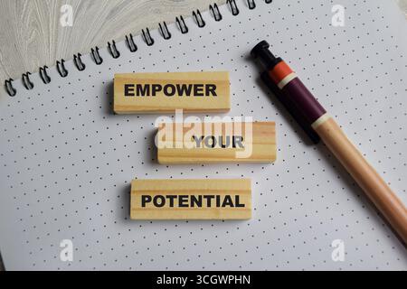 The word Empower your potential on stacked wooden cubes on the table. Business and finance concept Stock Photo
