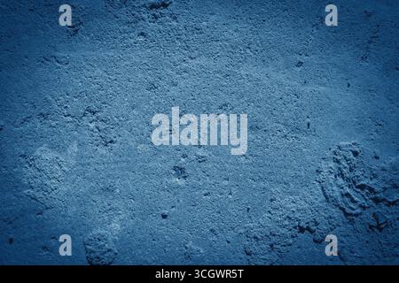Old blue wall in spots, cracks, stains. Painted concrete wall in abstract grunge style loft. Stock Photo