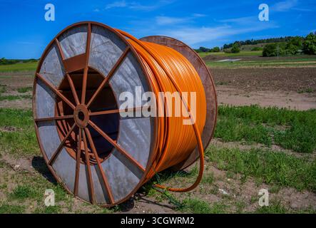 Construction site with a fiber optic cable roll for digital broadband internet communication. Stock Photo