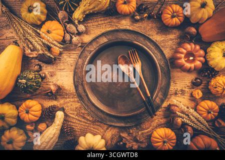 Festive Thanksgiving table setting with pumpkins and candles in autumn colors Stock Photo