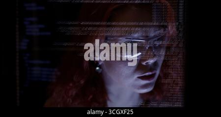Programmers and coding. Programmer or Developer working in dark room with computer code reflected on their monitor. Cybersecurity software development Stock Photo