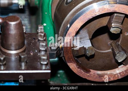 Turning a steel billet on a lathe with a cutter. Stock Photo