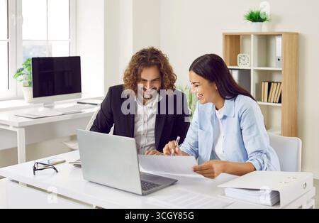 Business people sitting with laptop working with financial documents analyzing company in office. Stock Photo