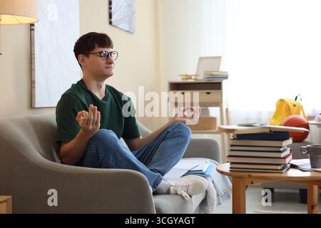 Student preparing for exam and meditating at home Stock Photo