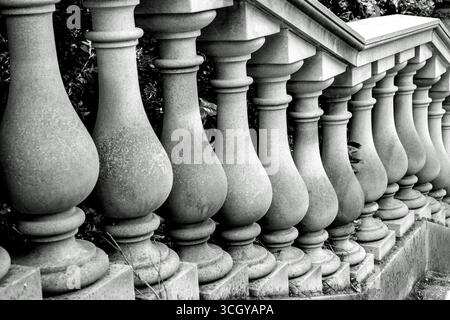 A black and white image of a ballustrade with stone balusters (pillars) on a set of garden steps Stock Photo