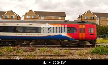A EMR East Midlands railway train travels through Peterborough to the Midlands and north of England. Stock Photo
