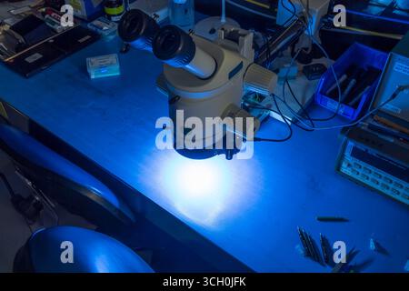 Microscope with blue light in research lab, USA Stock Photo