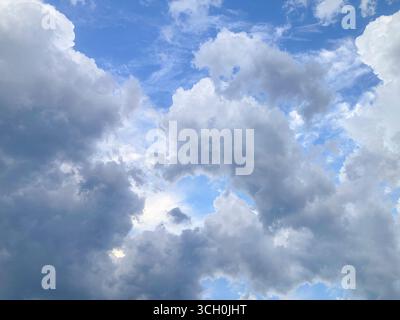 Beautiful white puffy clouds in blue sky Stock Photo