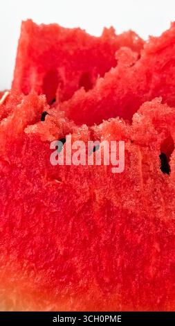 Pieces of ripe juicy red watermelon with seeds close-up on white background Stock Photo