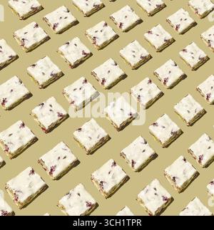 A flat lay food arrangement showing repeating rows of white nougat cubes with visible nuts, laid out diagonally across a beige backdrop to create a se Stock Photo