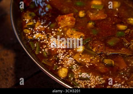 Close-up of a traditional Valencian paella with the white rice just added. Stock Photo