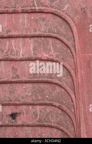 Macro Photography of old stacked red plastic chair showing repeated curves graphic Stock Photo
