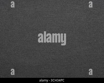 The dark grey texture of this paper mimics a starless night sky, both enigmatic and profound Stock Photo