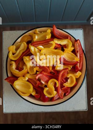 Bowl of Sliced Red and Yellow Bell Peppers for Homemade Preserves Stock Photo