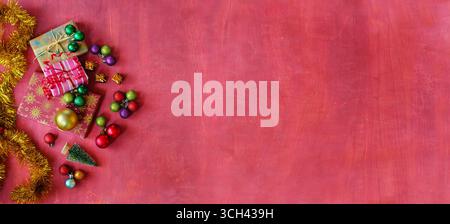 Christmas shopping and christmas present concept with gift wrapped Christmas present boxes and Christmas balls and decoration. Flat lay Stock Photo