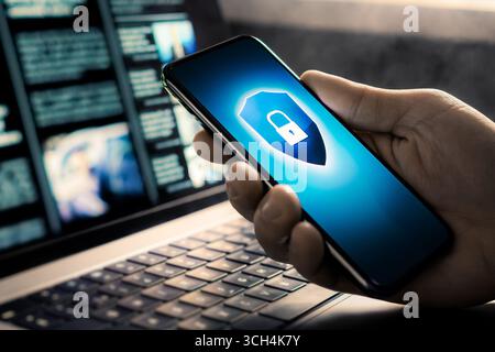 Phone cyber security to protect data from fraud, hacker, identity theft or scam. Online privacy and secure use of smartphone and laptop computer. Stock Photo