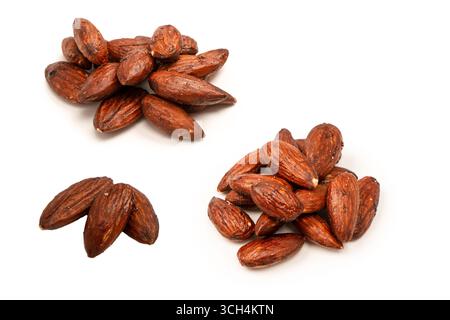 A group of caramelized almonds isolated on a white background. Stock Photo