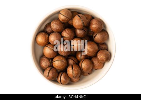 Macadamia nuts in a shell isolated on a white background. Top view. Stock Photo